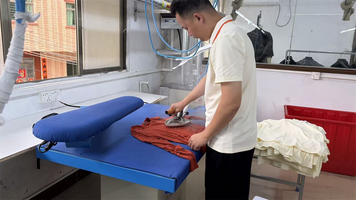Pressing station preparing garments for shipment